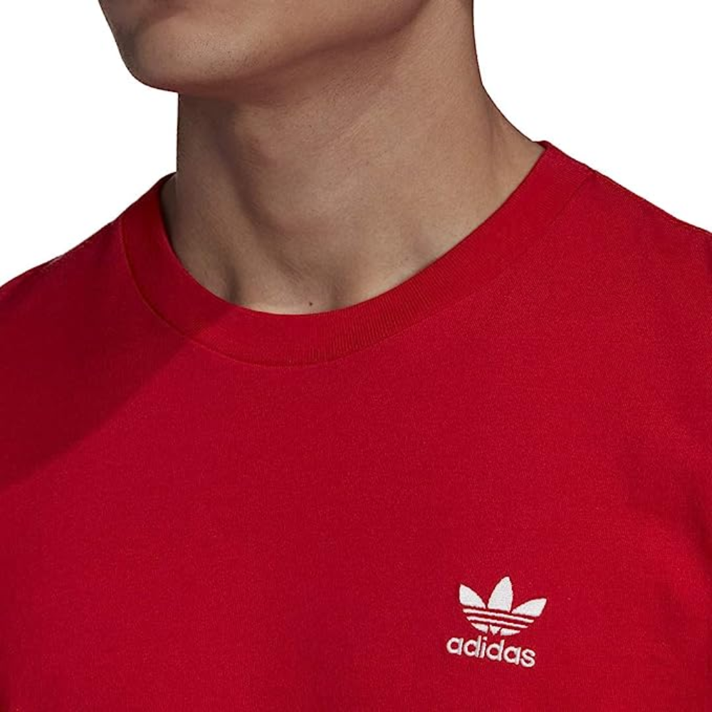Man wearing adidas Originals Men's Trefoil Essential Tee in Scarlet