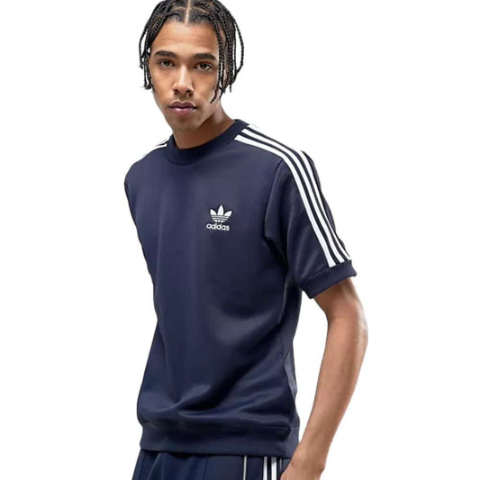 A man wearing adidas Men Originals CNTP SS Crew Tee