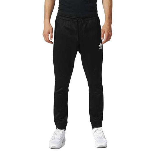 A man wearing adidas Men's Originals BLK/WVN T90 TIRO Track Pants