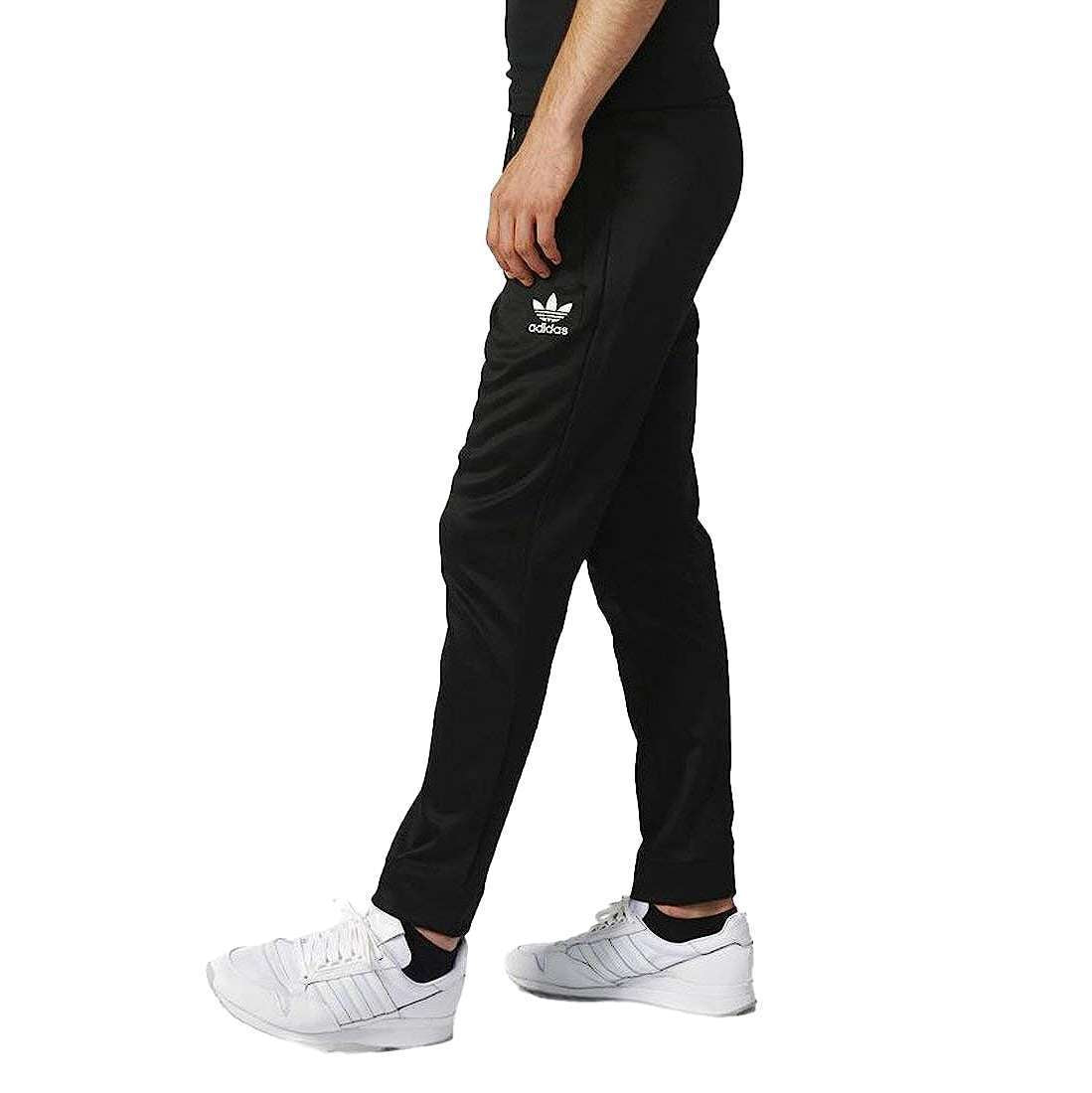 A man wearing adidas Men's Originals BLK/WVN T90 TIRO Track Pants