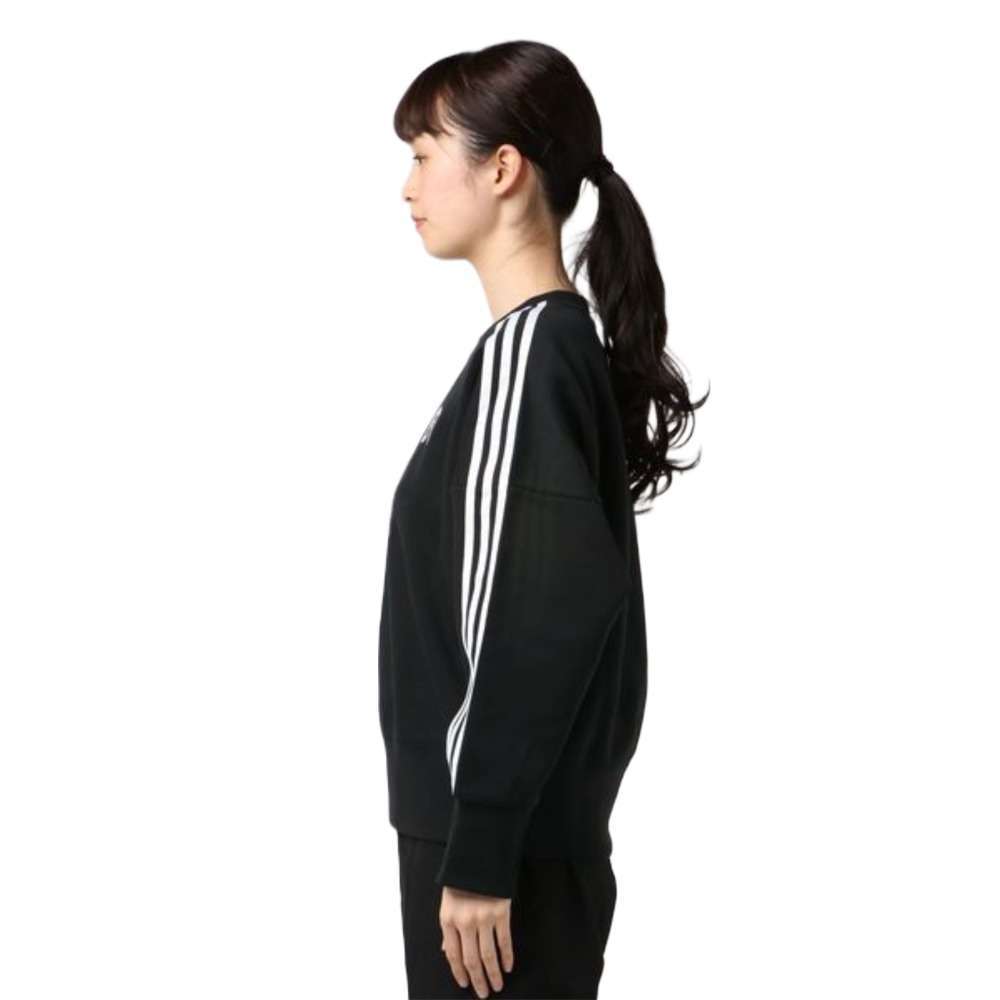 A woman wearing adidas Women's Originals Crewneck Sweatshirt