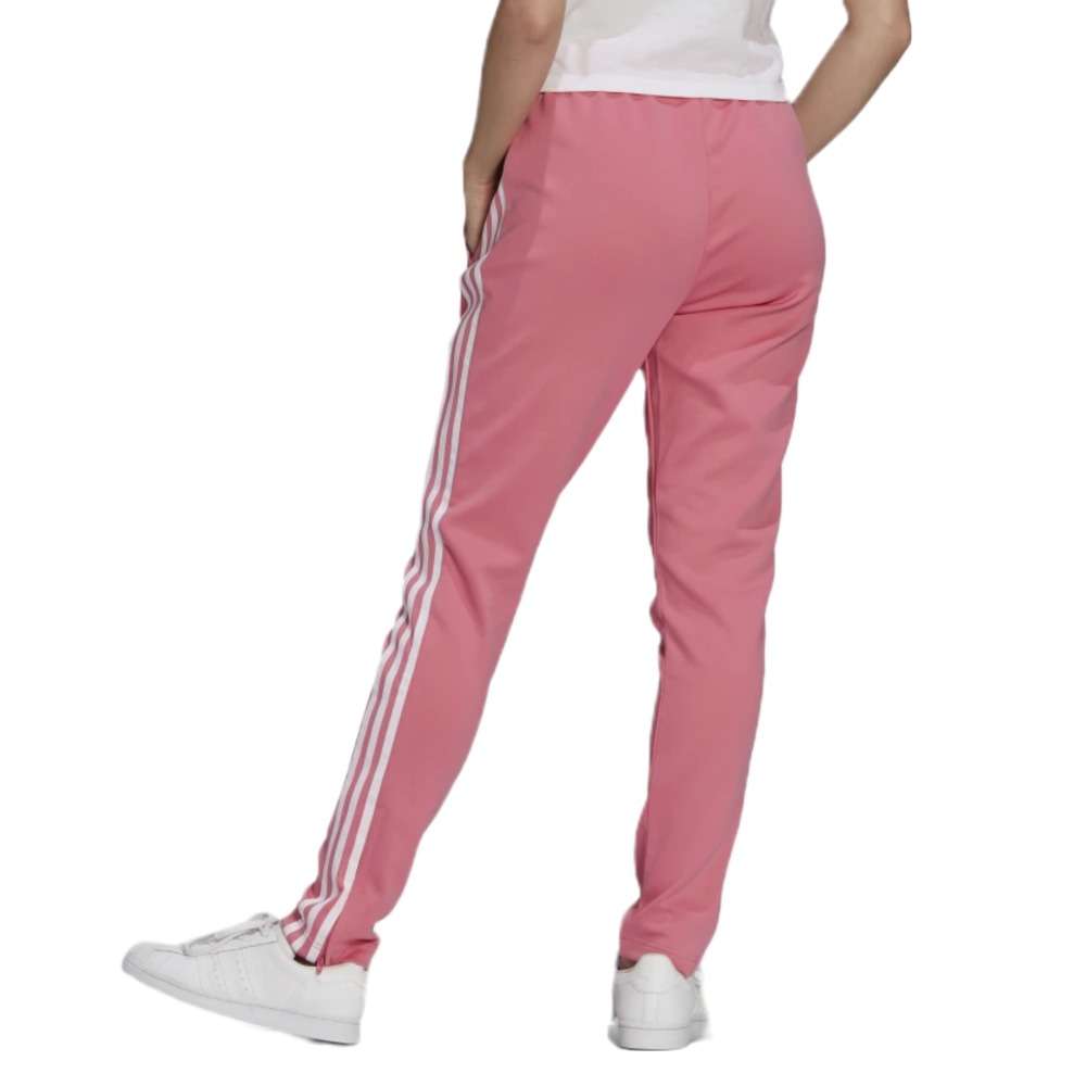 A woman wearing the adidas Originals Women's Primeblue Superstar Track Pants