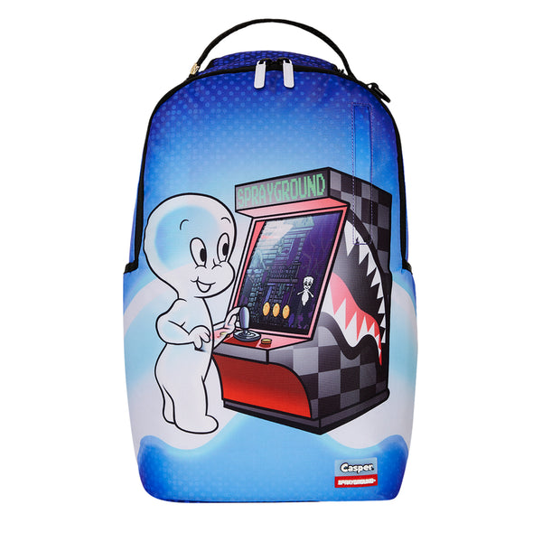 SPRAYGROUND Casper Ghost Player One DLXSR Backpack with gamer-themed design, sharkmouth graphic, and padded straps, made from water-resistant polyester.