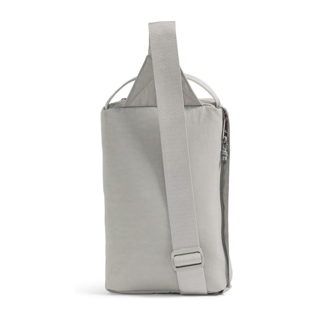 The North Face Berkeley Field Bag in beige with black strap and zippered compartments, styled as a compact crossbody bag.