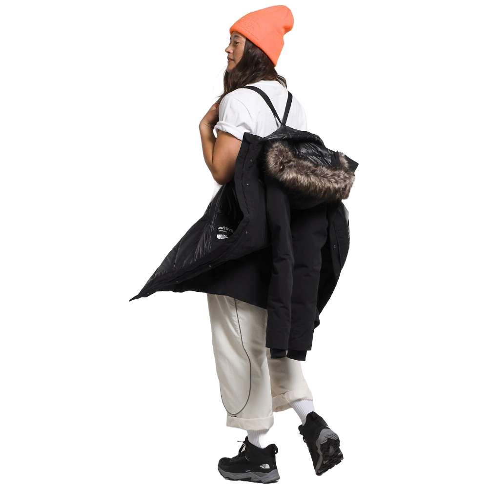 A woman wearing the North Face Women’s Arctic Parka Premium in sleek black