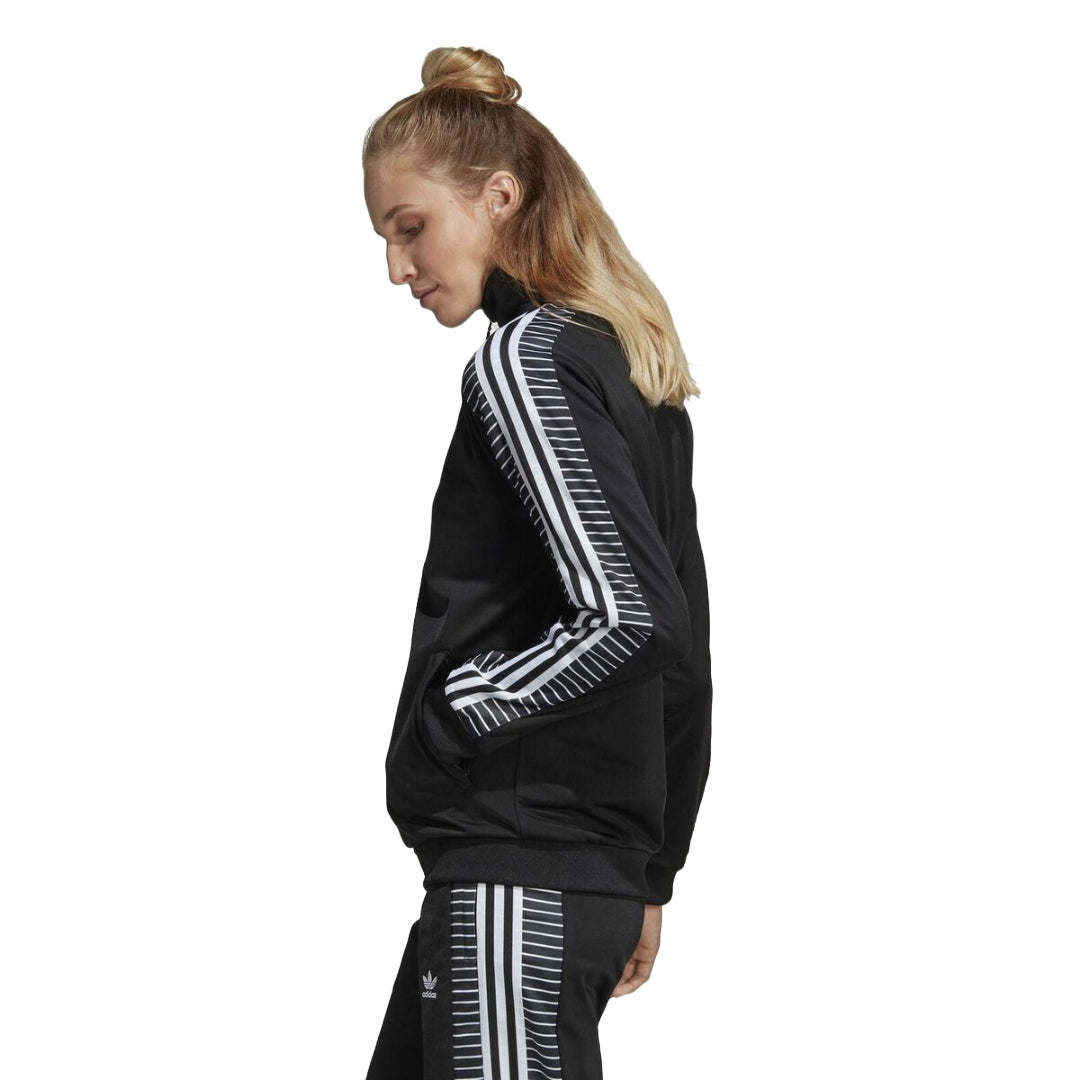 Stand out in style with adidas Originals Women's Track Top, a sporty and chic jacket featuring the iconic trefoil logo for a fashionable edge.