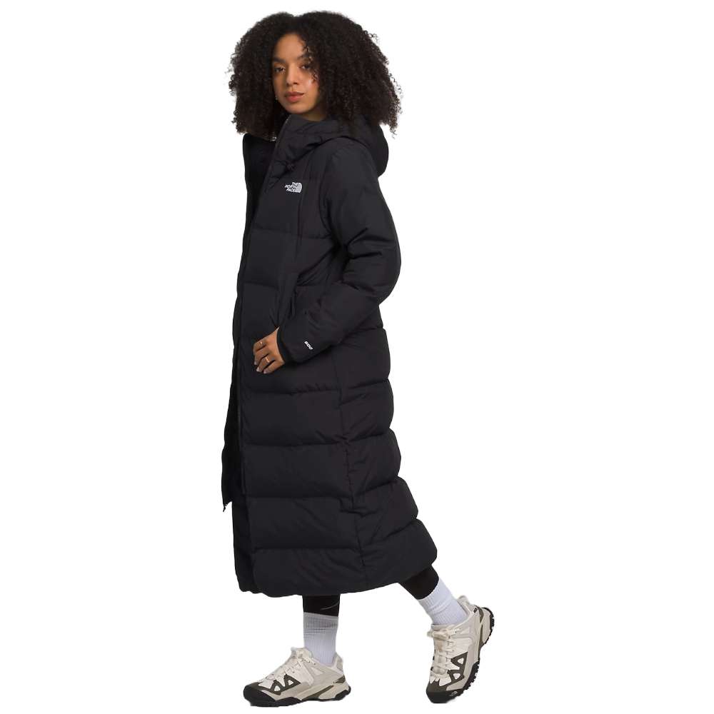 A sleek black north face women's triple c parka worn by women.