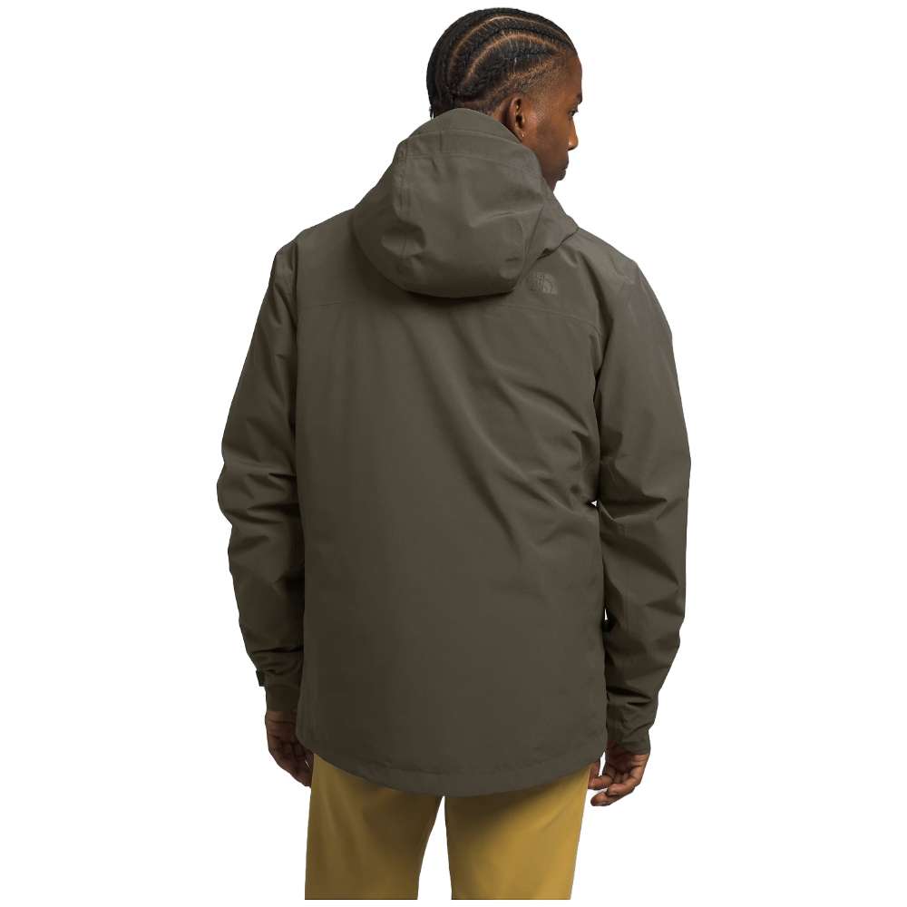 A man wearing The North Face Men’s ThermoBall™ Eco Triclimate® Jacket in taupe green, braving the elements.