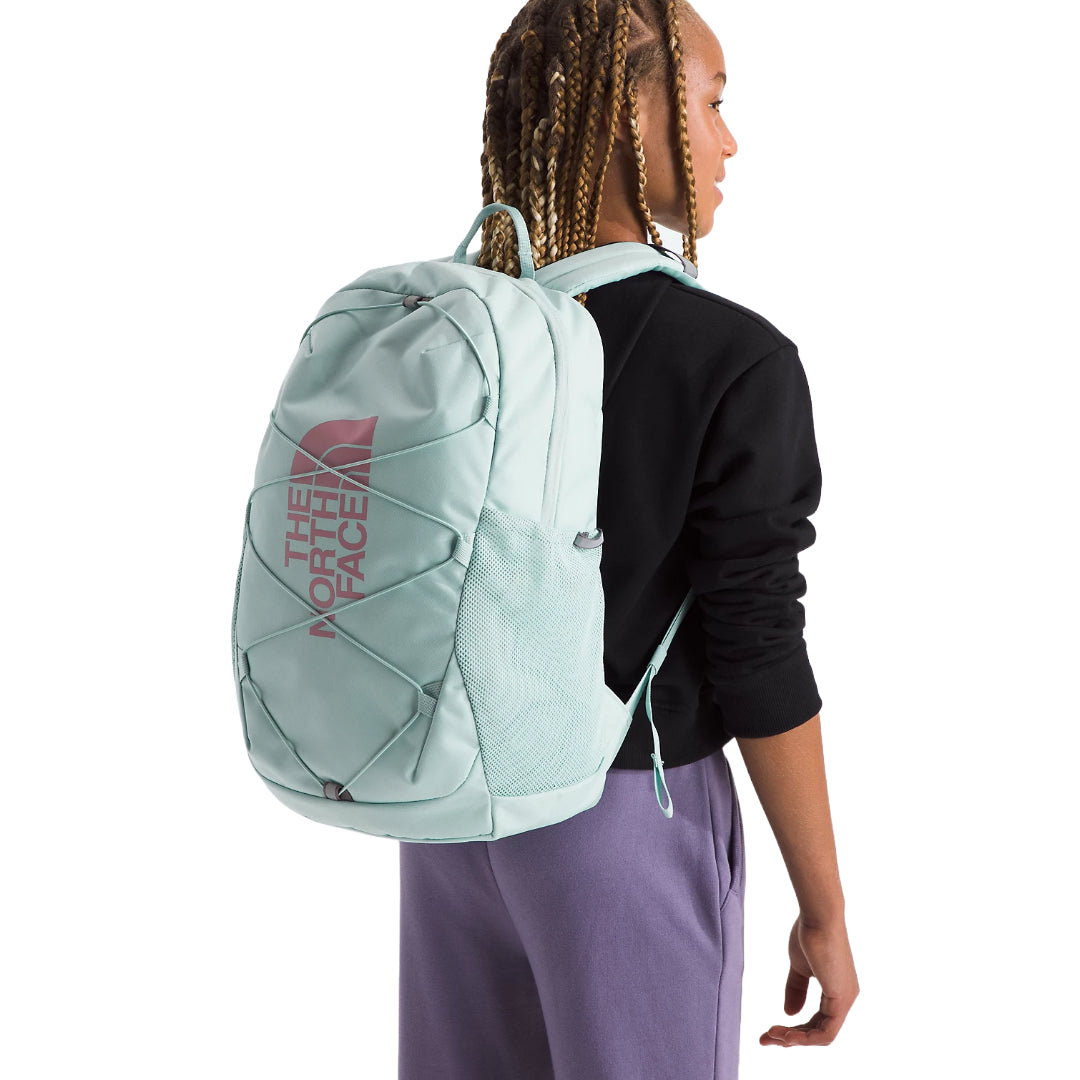 The North Face Youth Court Jester Backpack in blue, featuring a fun design, spacious compartments, and adjustable shoulder straps.