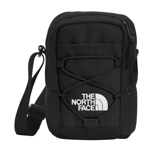The North Face Jester Crossbody in black, featuring a compact design with multiple compartments and an adjustable strap.
