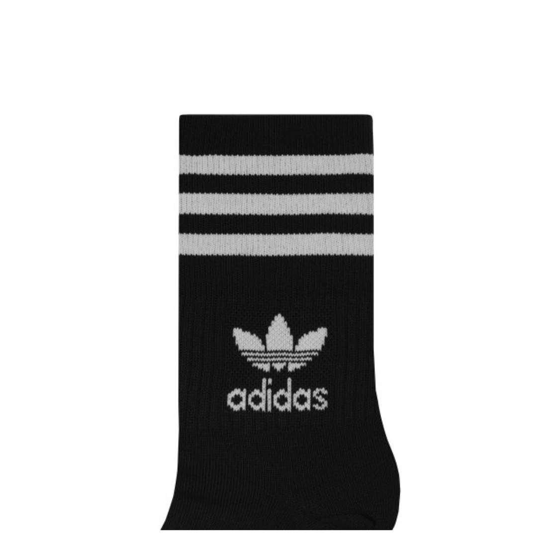 A close-up view of adidas Originals MID Cut Crew Socks in black and white.