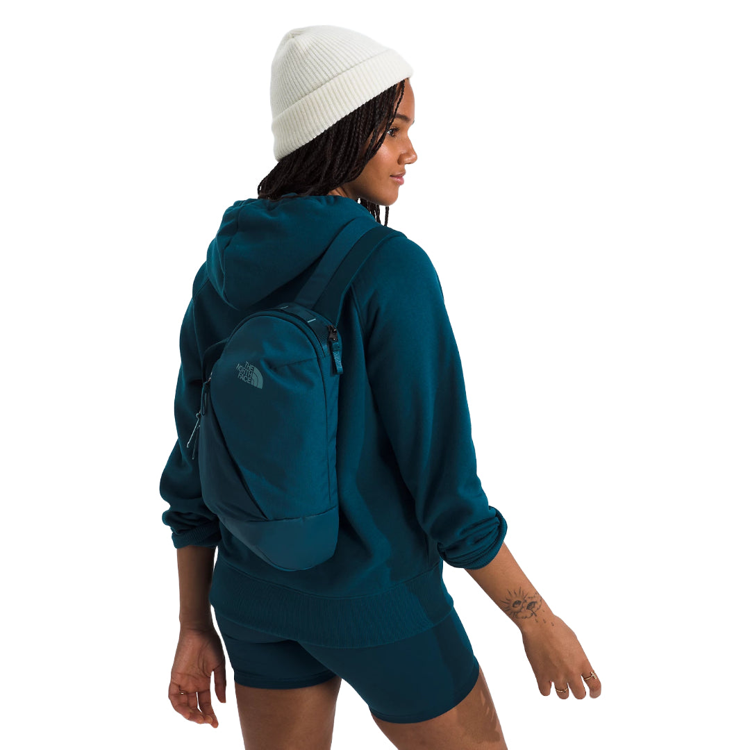 The North Face Isabella Sling Bag in black, featuring a compact design with multiple compartments and an adjustable strap.