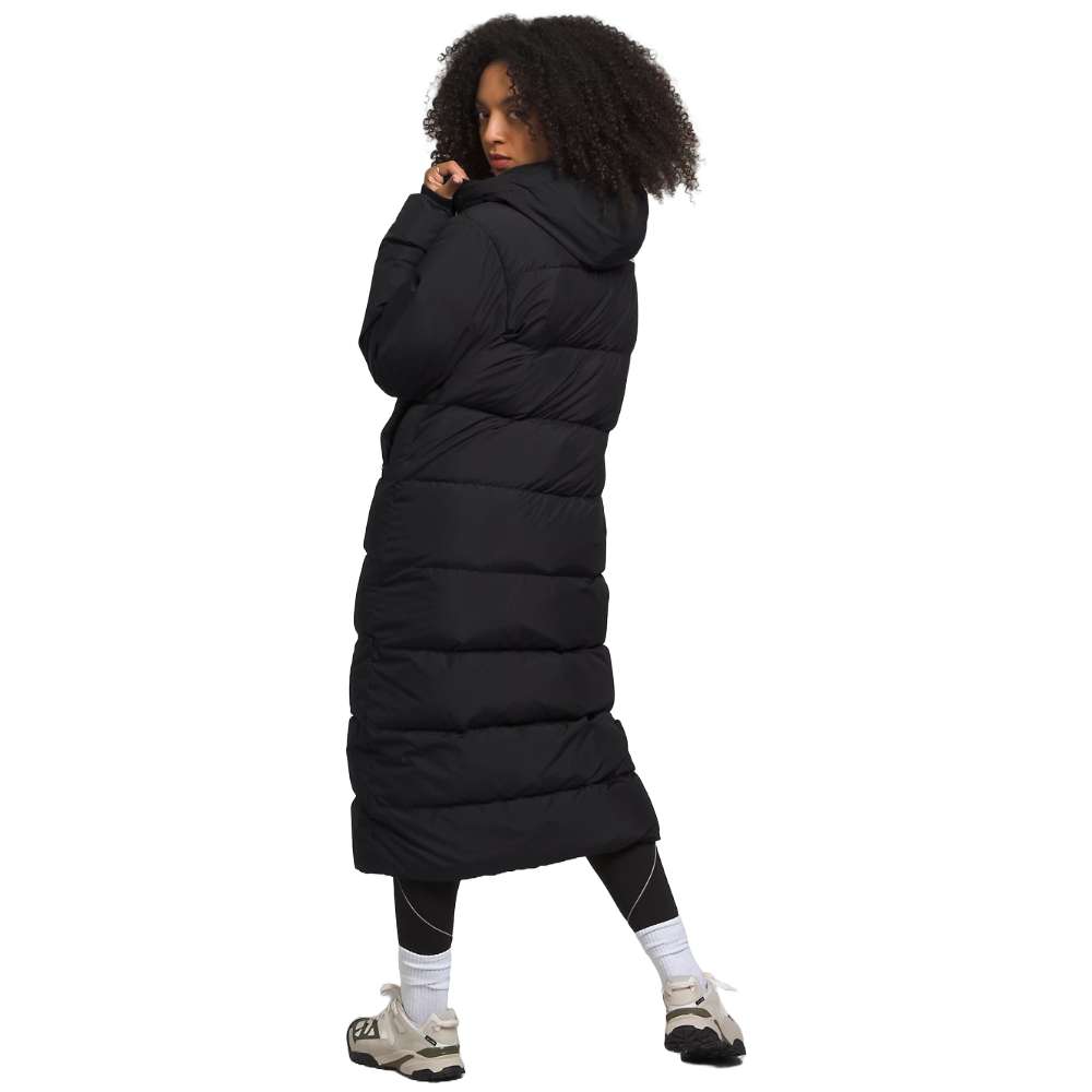 A sleek black north face women's triple c parka worn by women.