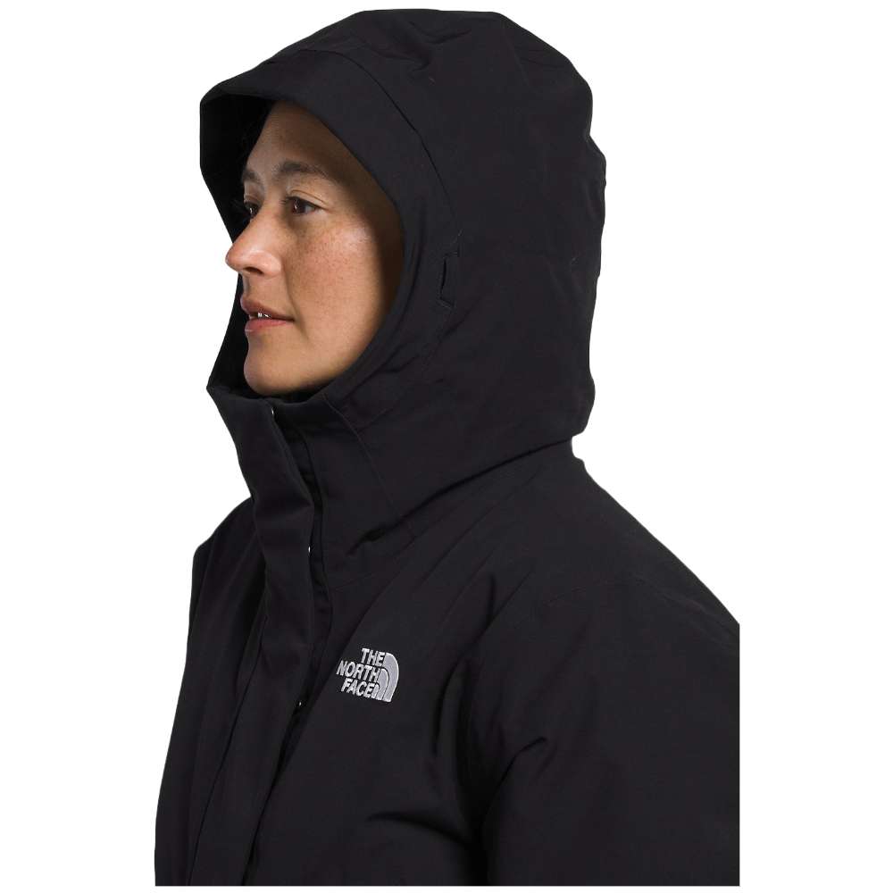 A woman wearing the North Face Women’s Arctic Parka Premium in sleek black