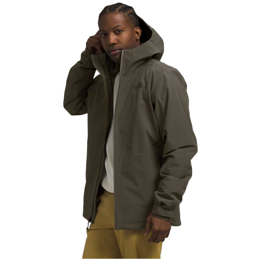 A man wearing The North Face Men’s ThermoBall™ Eco Triclimate® Jacket in taupe green, braving the elements.