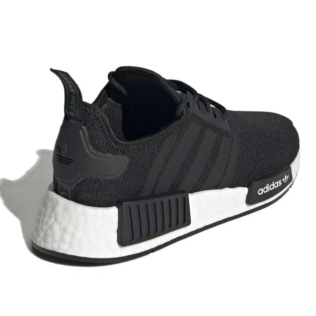 A pair of black adidas Originals Junior NMD_R1 shoes with white detailing.