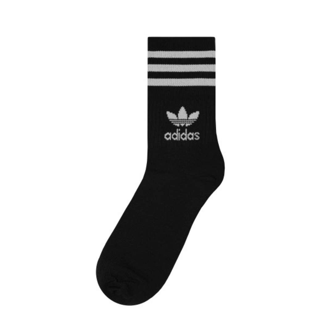 A close-up view of adidas Originals MID Cut Crew Socks in black and white.