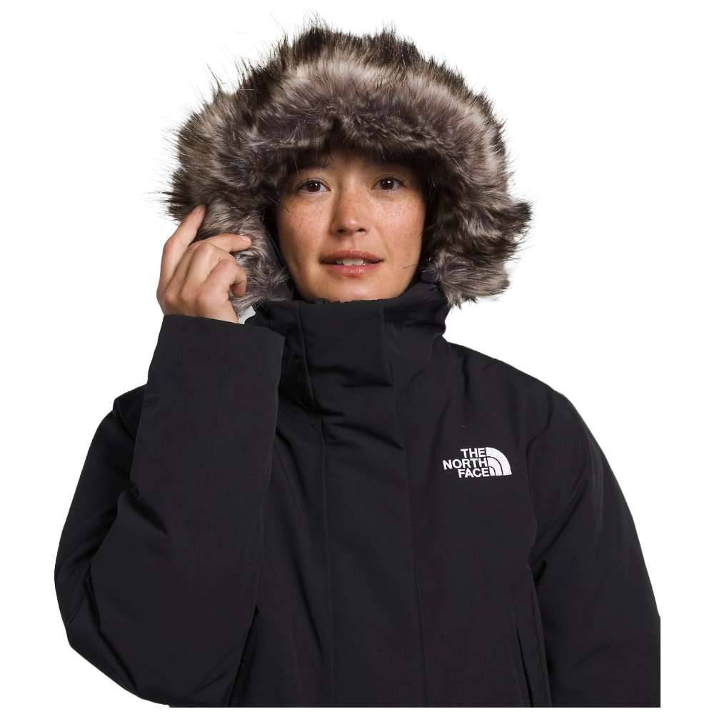 A woman wearing the North Face Women’s Arctic Parka Premium in sleek black