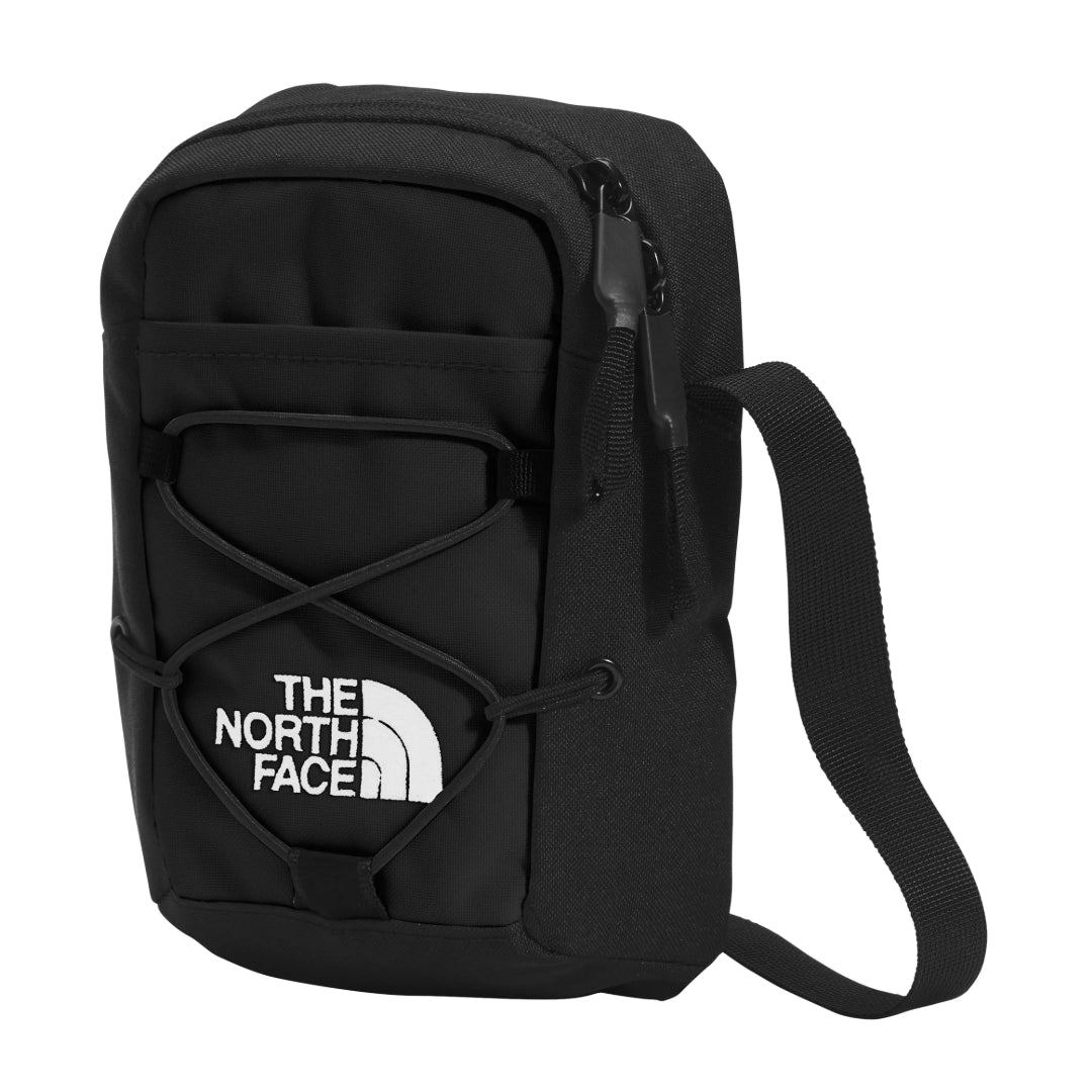 The North Face Jester Crossbody in black, featuring a compact design with multiple compartments and an adjustable strap.