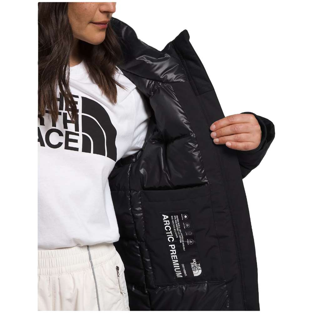 A woman wearing the North Face Women’s Arctic Parka Premium in sleek black