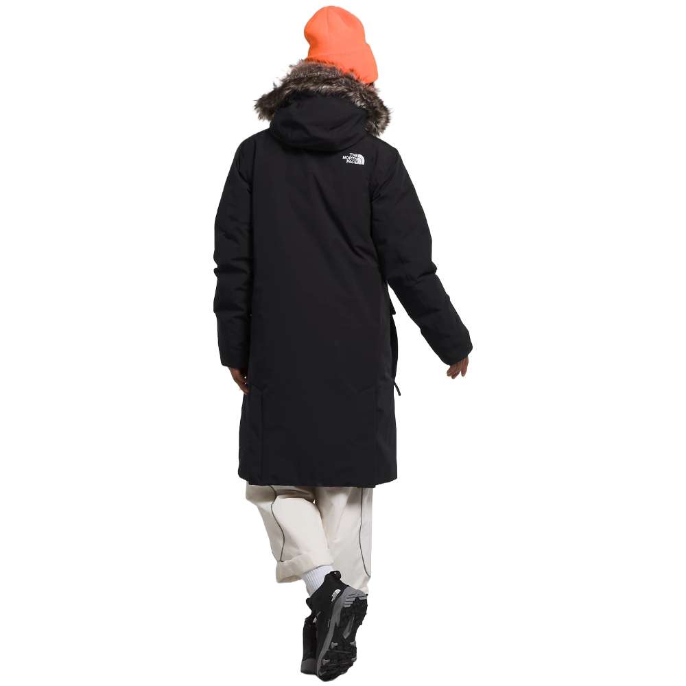 A woman wearing the North Face Women’s Arctic Parka Premium in sleek black