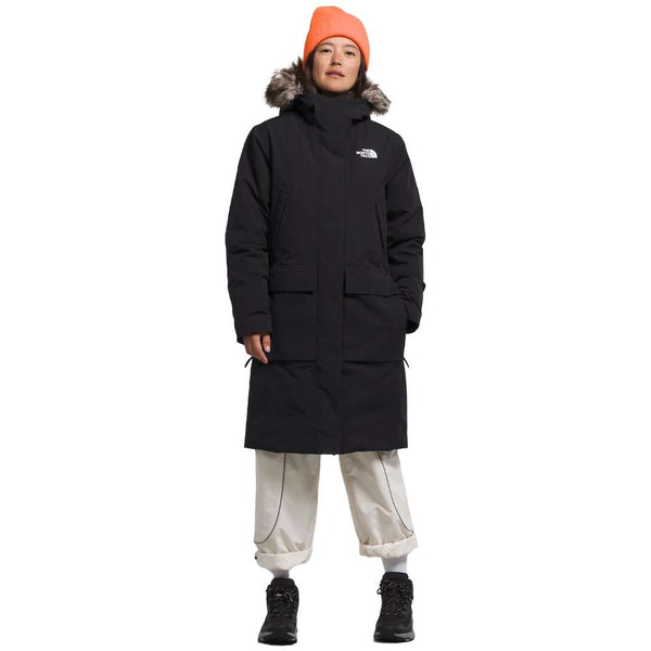 A woman wearing the North Face Women’s Arctic Parka Premium in sleek black.