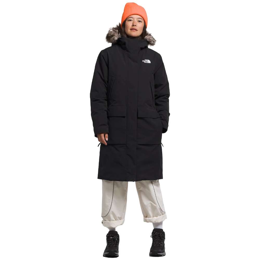 A woman wearing the North Face Women’s Arctic Parka Premium in sleek black.