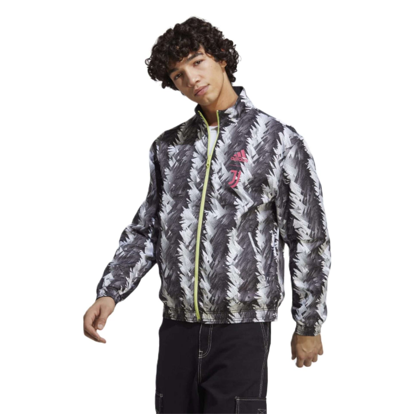 A reversible track jacket in black featuring the Adidas and Juventus logos, perfect for showing team support. The front of the jacket has the Adidas logo on the right side of the chest, while the left side features the iconic Juventus crest. The jacket is made of high-quality materials and has a sleek design.