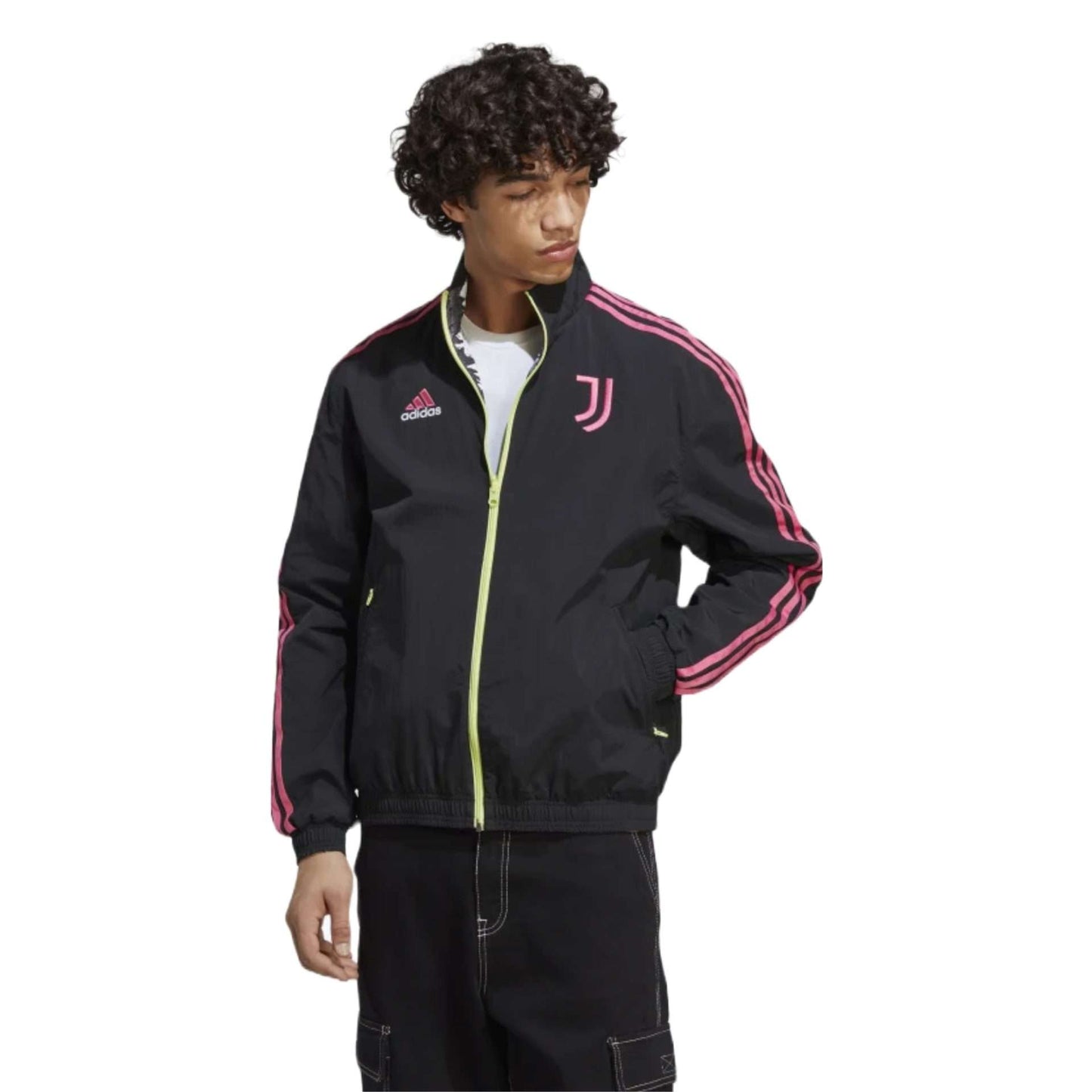 A reversible track jacket in black featuring the Adidas and Juventus logos, perfect for showing team support. The front of the jacket has the Adidas logo on the right side of the chest, while the left side features the iconic Juventus crest. The jacket is made of high-quality materials and has a sleek design.