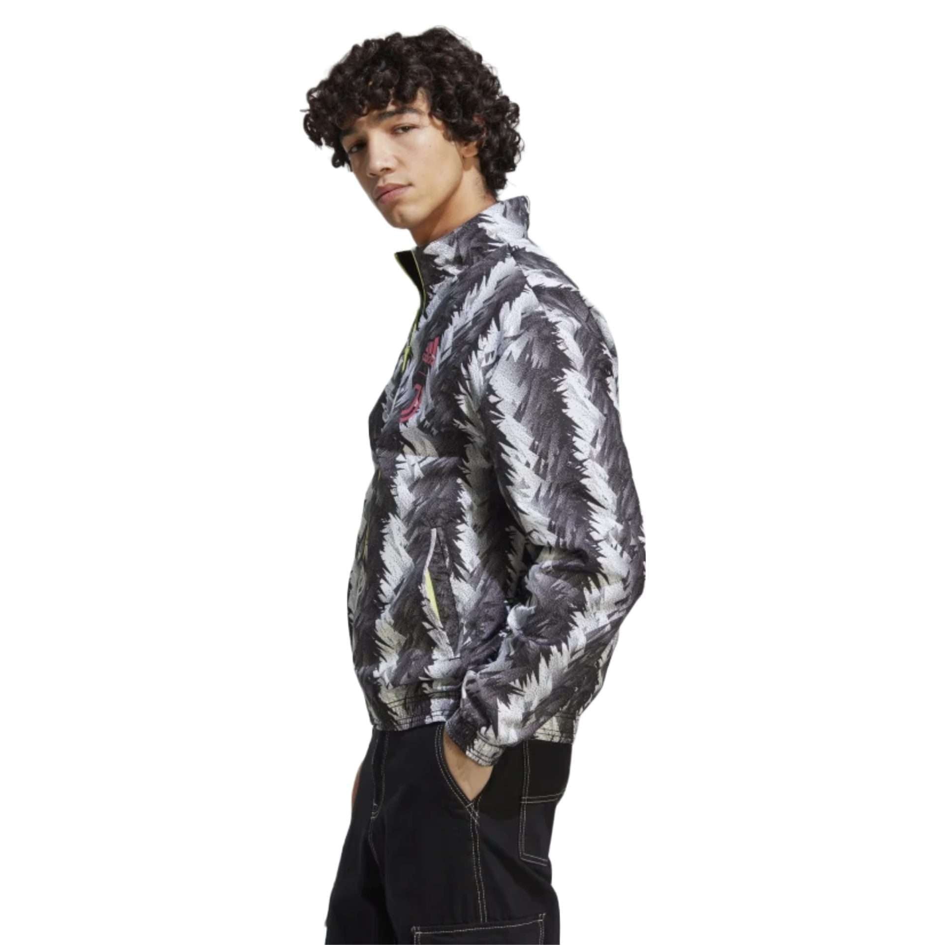 A reversible track jacket in black featuring the Adidas and Juventus logos, perfect for showing team support. The front of the jacket has the Adidas logo on the right side of the chest, while the left side features the iconic Juventus crest. The jacket is made of high-quality materials and has a sleek design.