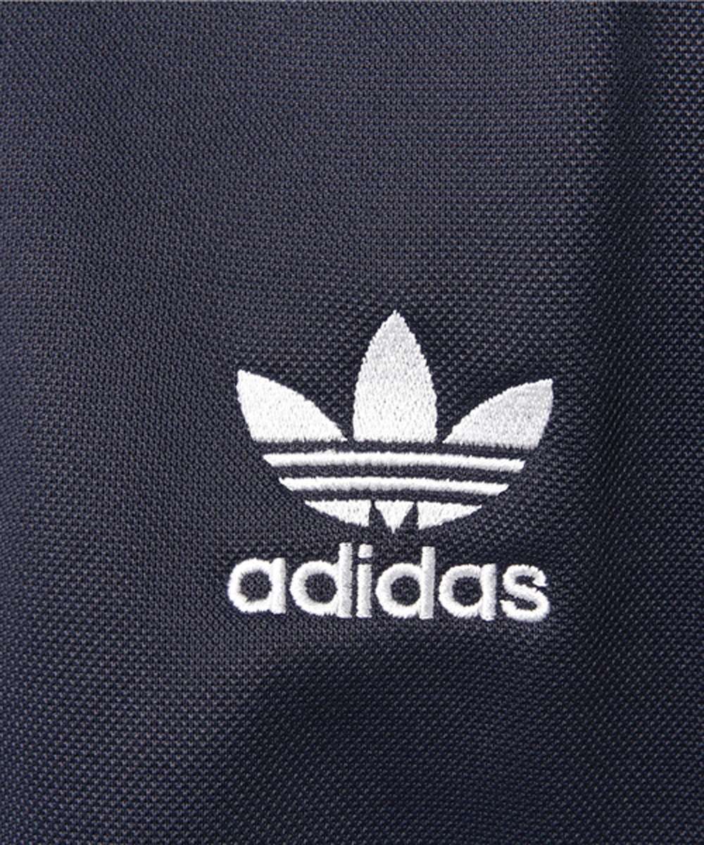 A man wearing adidas Men Originals CNTP SS Crew Tee