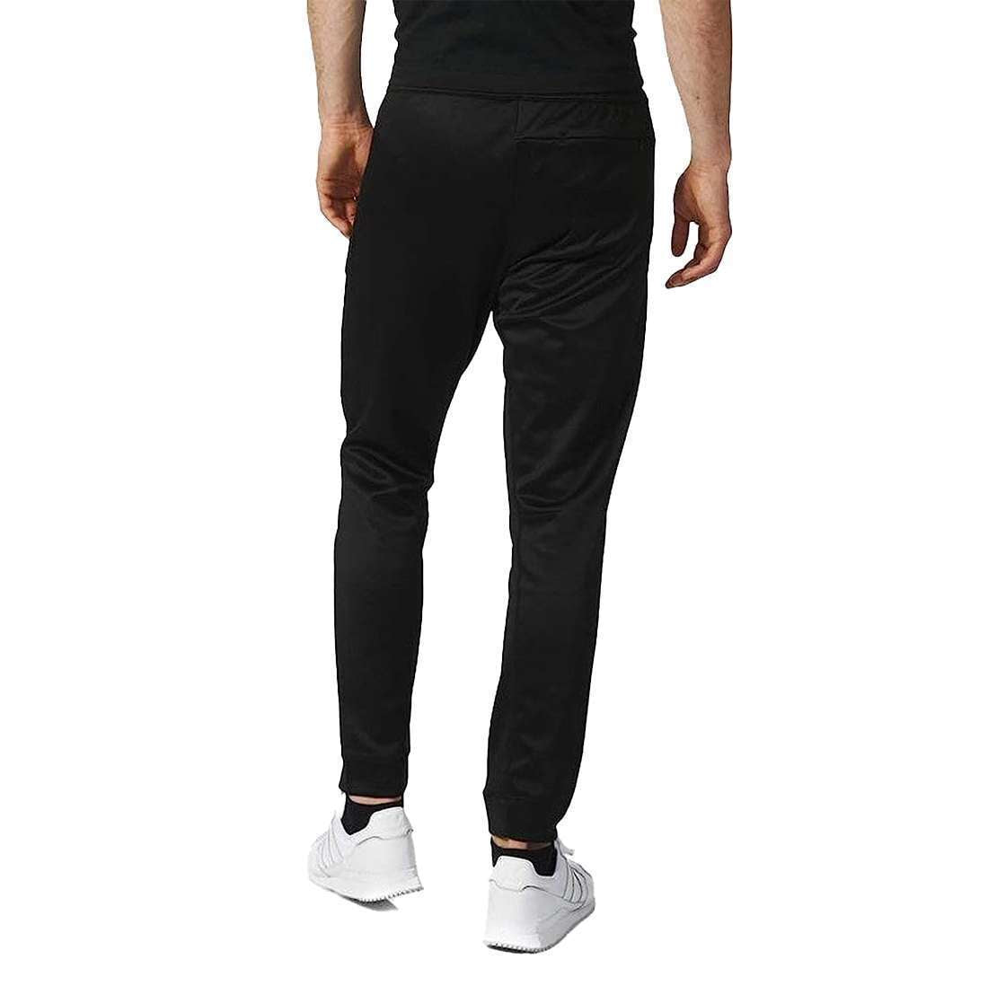 A man wearing adidas Men's Originals BLK/WVN T90 TIRO Track Pants