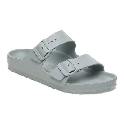 Person wearing Birkenstock Arizona EVA Essentials sandals, featuring two adjustable straps and a lightweight waterproof design, ideal for beach or poolside casual wear