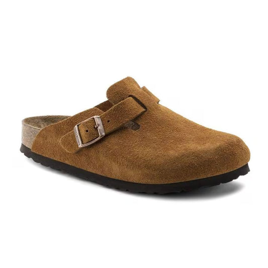 Closed-toe clog featuring a cushioned soft footbed, adjustable buckle strap, contoured cork-latex support, and a classic slip-on design for everyday comfort