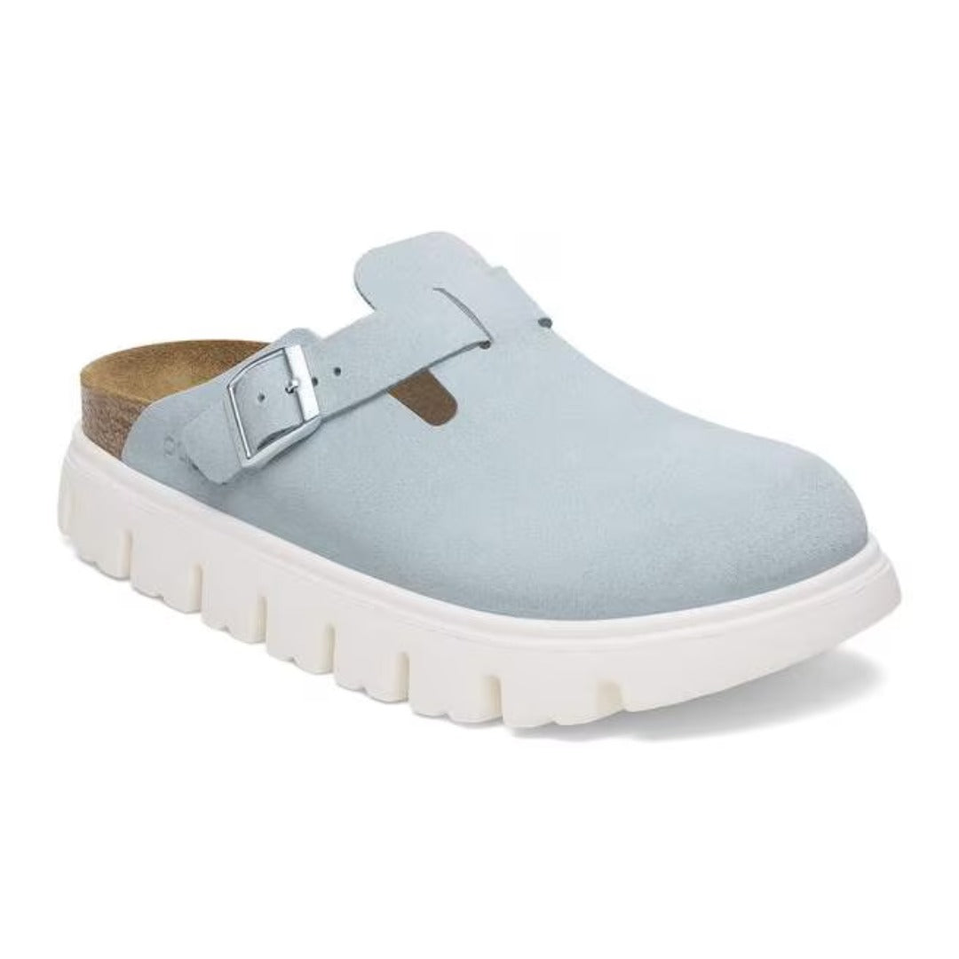 Chunky platform clog featuring a closed-toe design, adjustable buckle strap, contoured footbed, and elevated sole for modern everyday comfort and style