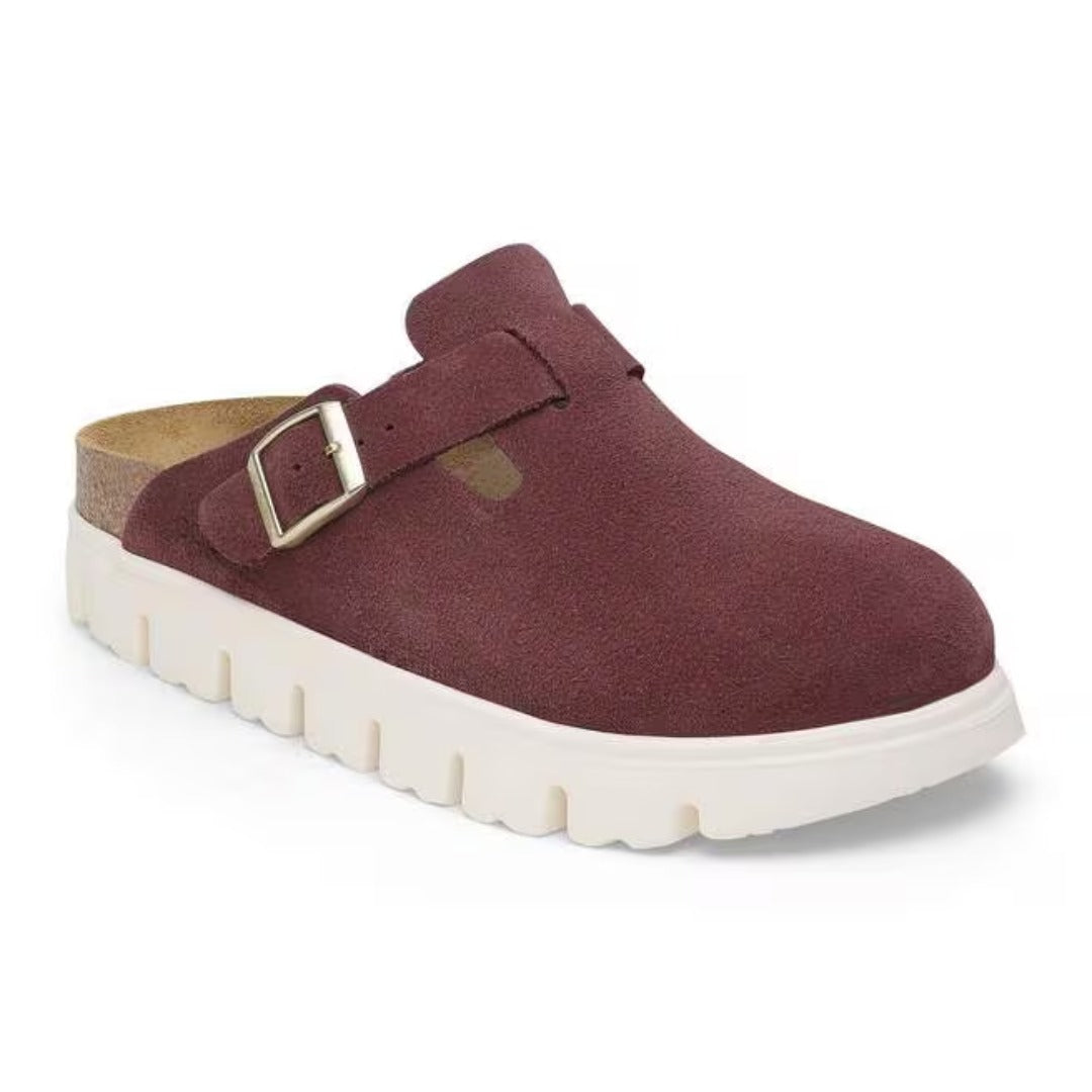 Chunky platform clog featuring a closed-toe design, adjustable buckle strap, contoured footbed, and elevated sole for modern everyday comfort and style
