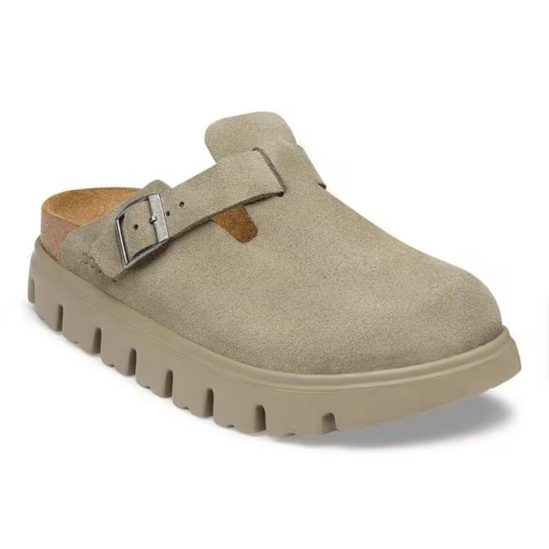 Chunky platform clog featuring a closed-toe design, adjustable buckle strap, contoured footbed, and elevated sole for modern everyday comfort and style