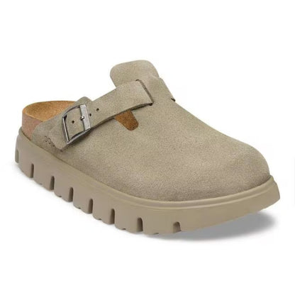 Chunky platform clog featuring a closed-toe design, adjustable buckle strap, contoured footbed, and elevated sole for modern everyday comfort and style