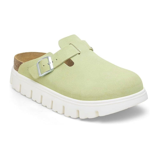 Chunky platform clog featuring a closed-toe design, adjustable buckle strap, contoured footbed, and elevated sole for modern everyday comfort and style