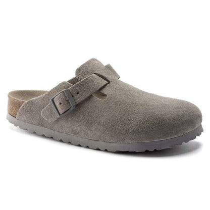 Women wearing Birkenstock Boston Soft Footbed clogs, closed-toe suede slip-on shoes with buckle strap and cushioned cork footbed, styled for casual everyday wear.
