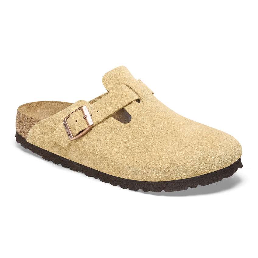 Women wearing Birkenstock Boston Soft Footbed clogs, closed-toe suede slip-on shoes with buckle strap and cushioned cork footbed, styled for casual everyday wear.