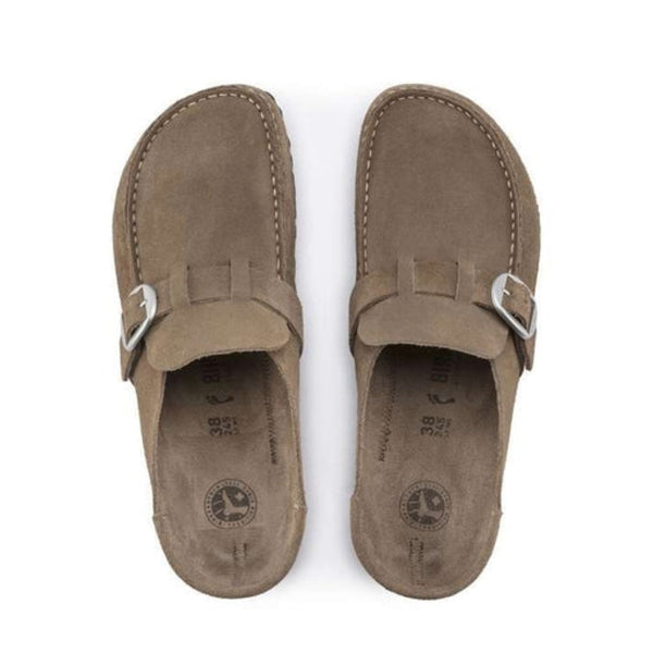Slip-on clog featuring a structured upper, adjustable buckle strap, contoured cork-latex footbed, and durable outsole for everyday comfort and casual wear