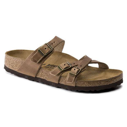 Strappy sandal featuring slim crisscross adjustable straps, a contoured cork-latex footbed, and a lightweight design for stylish everyday comfort