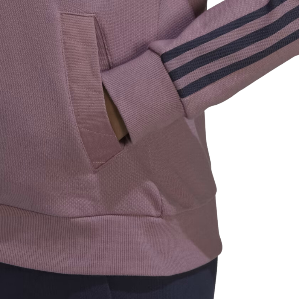 Adidas Women's Tiro Jacket in Magic Mauve, inspired by soccer fan culture and made with 100% cotton French terry.