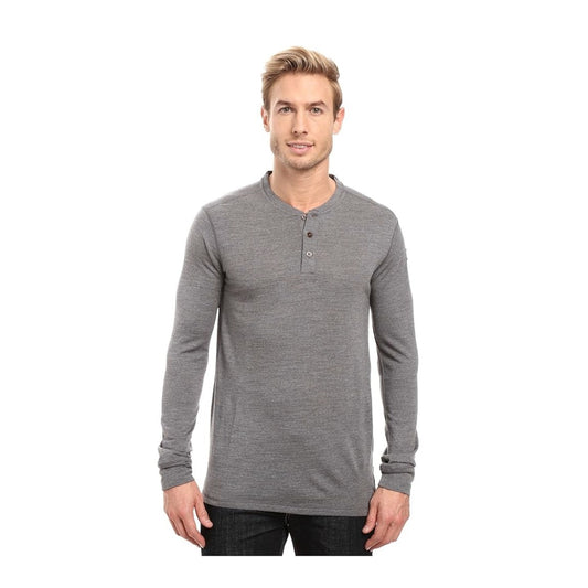 Fjällräven merino wool henley long sleeve shirt with button neckline, lightweight base-layer design, worn for outdoor or casual cold-weather comfort