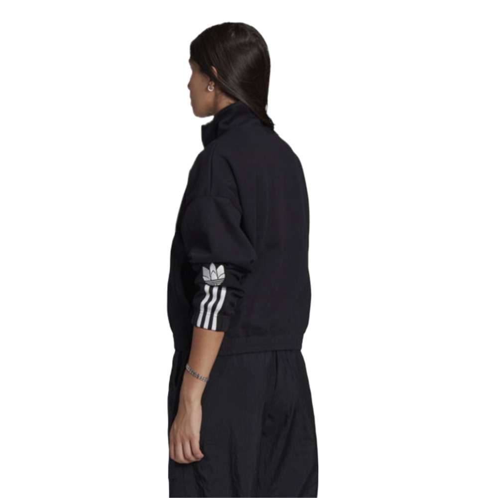 A person wearing the adidas Originals 3-D Trefoil Track Top