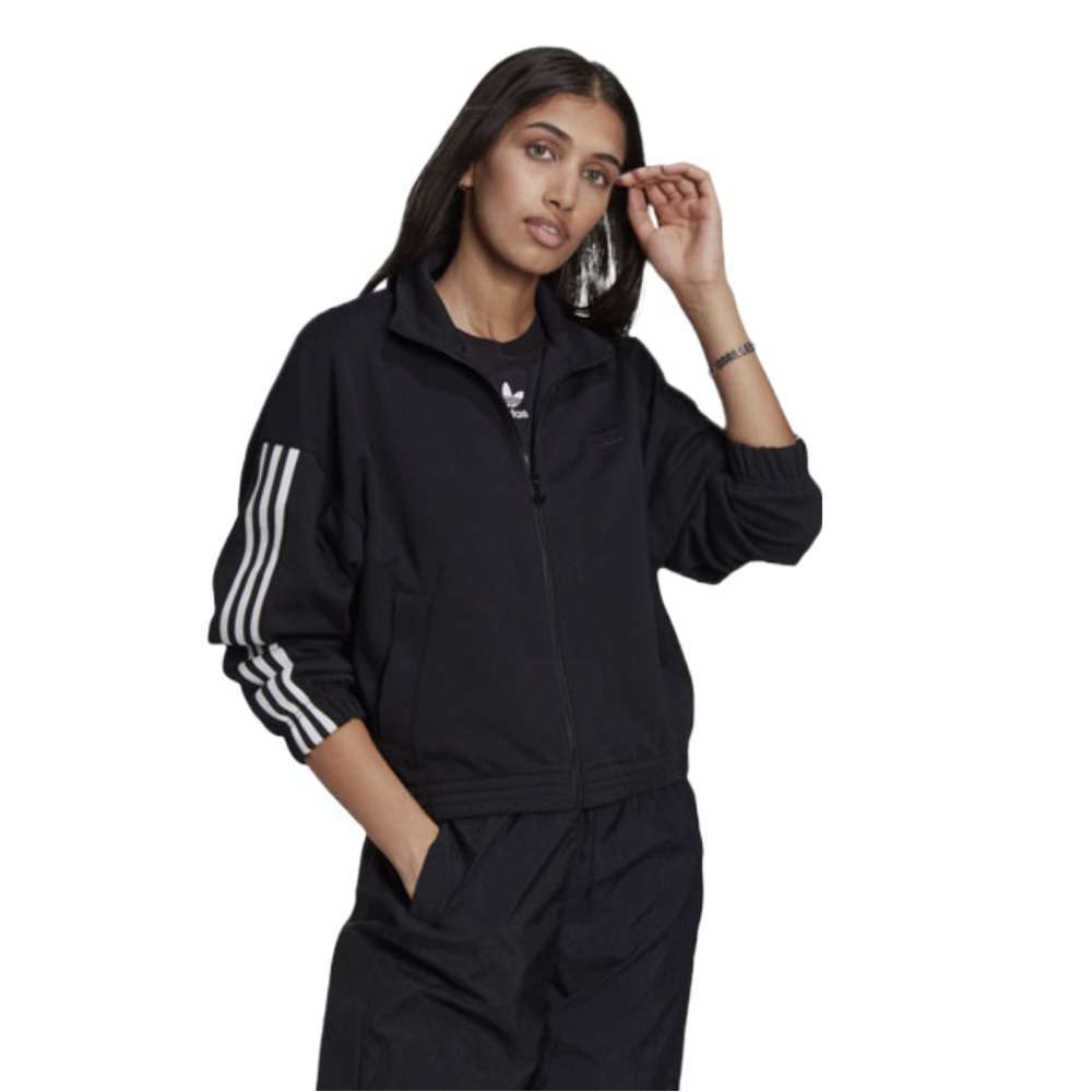 A person wearing the adidas Originals 3-D Trefoil Track Top