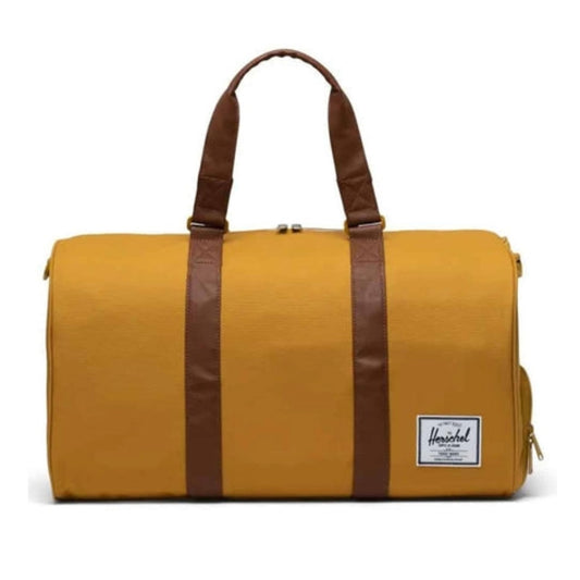Herschel Novel duffle bag with a large main compartment, side shoe pocket, dual handles, and shoulder strap for travel or gym use.