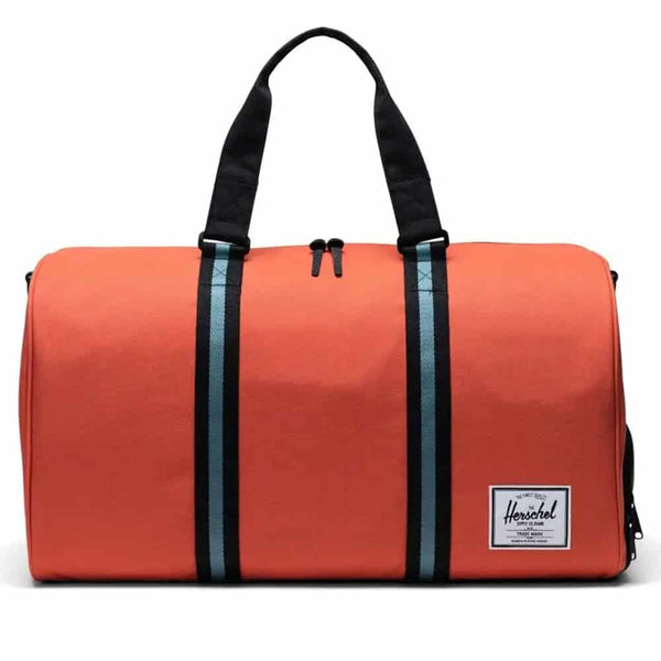 Herschel Novel duffle bag with a spacious main compartment, side shoe pocket, and dual carry handles, designed for travel and gym use.
