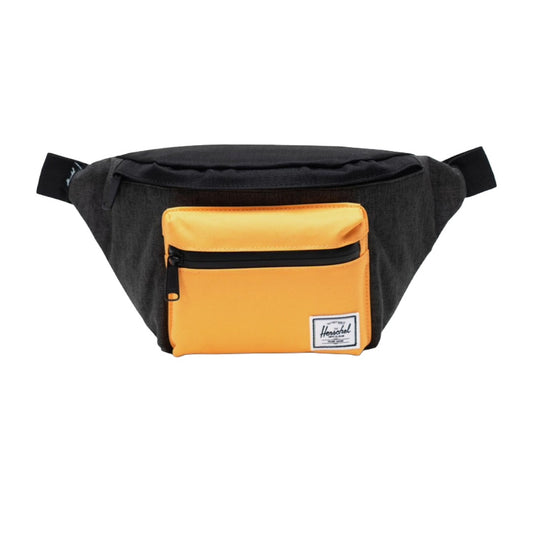 Herschel Seventeen hip pack worn crossbody, featuring a compact design with dual zippered compartments and adjustable strap for everyday use.